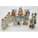 A group of Staffordshire ceramic figures and figure groups, 19th century, comprising: a pair of a...