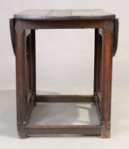 An English oak gateleg table, 17th century, the oval drop leaf top, on octagonal legs, joined by ...