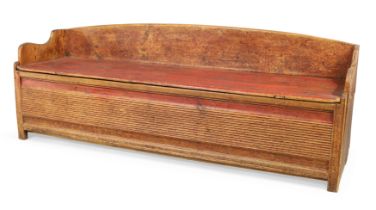 A Swedish parcel-gilt and red painted pine box bench, third quarter 19th century, the hinged top ...