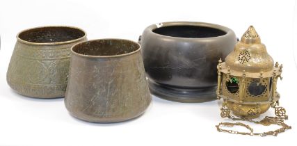 Two Middle Eastern copper and brass bowls, with inlaid and raised calligraphic motifs, the larges...