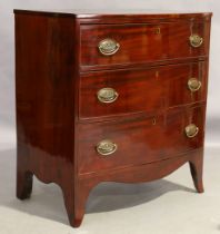 A Regency mahogany bow front chest, first quarter 19th century, with three graduated drawers, on ...