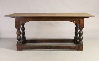 An English oak refectory table, 17th century and later, the plank top above turned supports, on b...