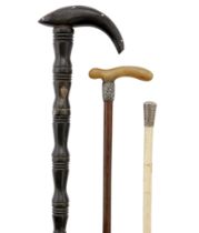 A white-metal mounted whale bone swagger stick, late 19th century, 68cm long; together with a buf...