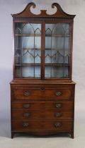 A George III mahogany secretaire bookcase, last quarter 18th century, the broken swan neck pedime...