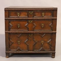 An English oak chest, 17th century and later, with three graduated drawers, two having geometric ...