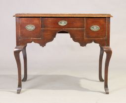 A George III oak lowboy, last quarter 18th century, with three drawers, on curved legs, 83cm high...