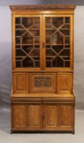 A Victorian light oak secretaire bookcase, last quarter 19th century, the carved cornice with pla...