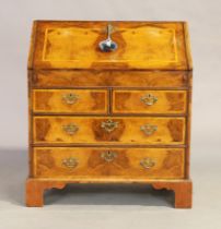 An English feather banded walnut bureau, George II style, last quarter 19th century, the fall fro...