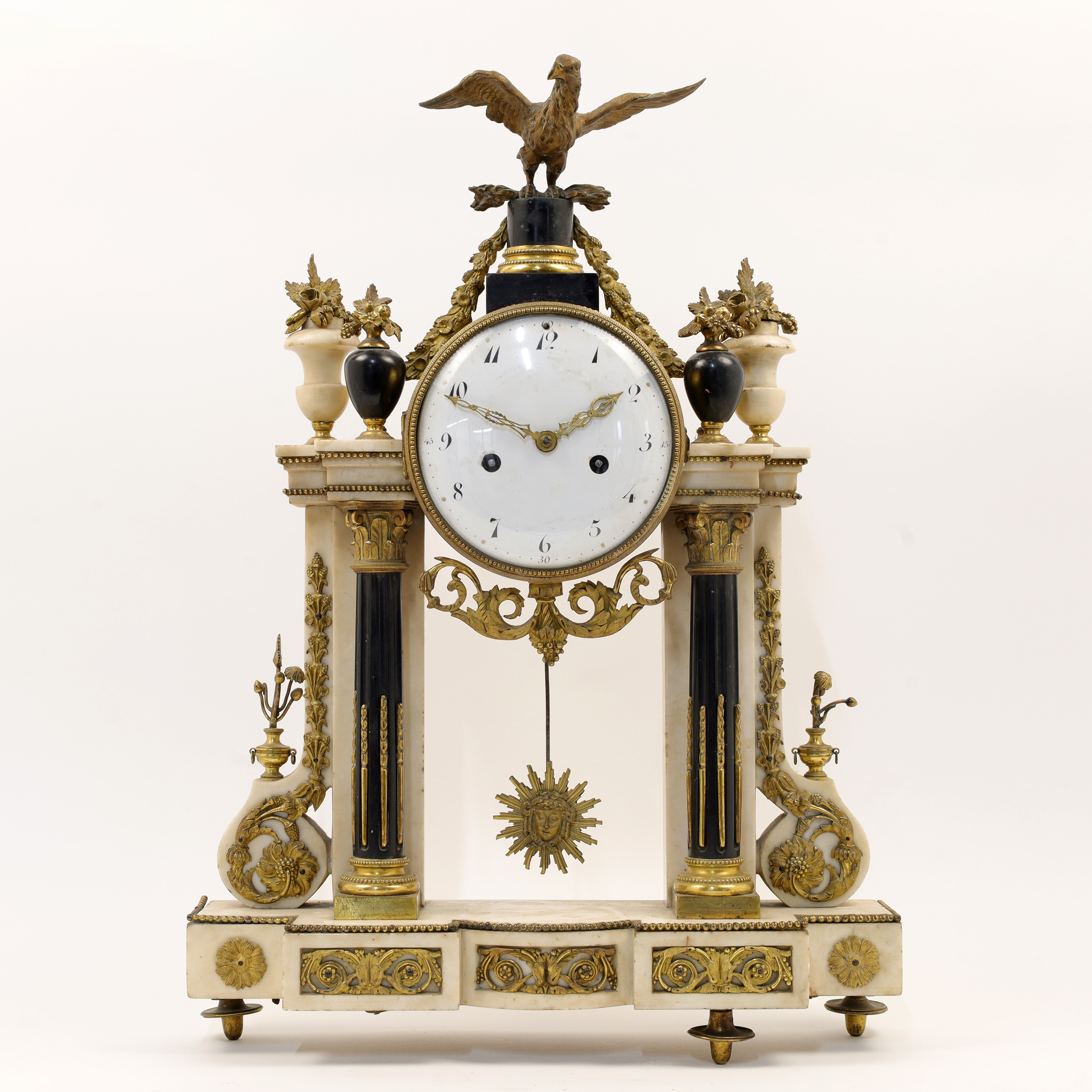 A Louis XVI style marble and gilt-bronze portico clock, 19th century, the architectural case surm...