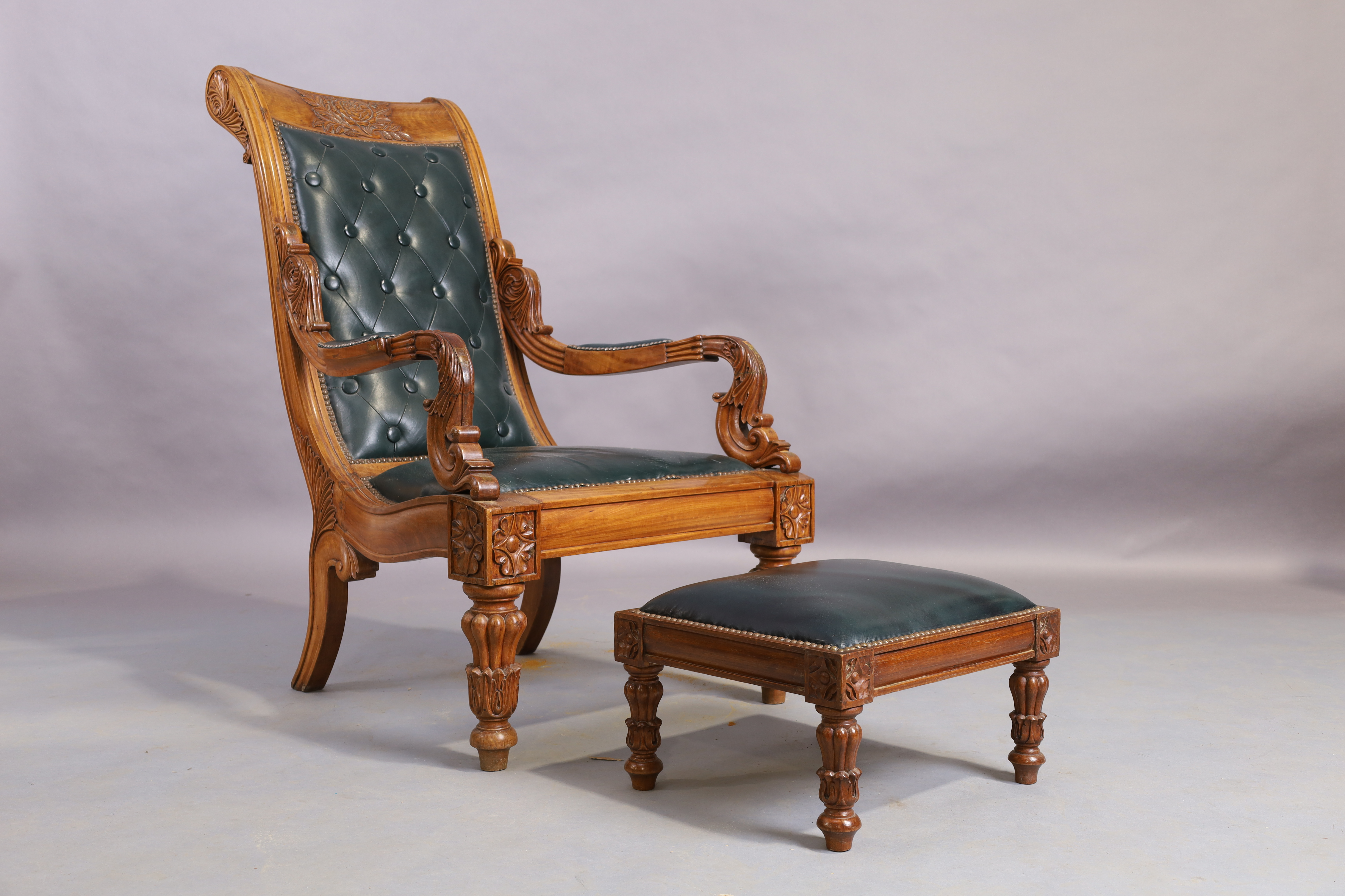 An Indonesian carved button back arm chair and stool, William IV style, 20th century (2)