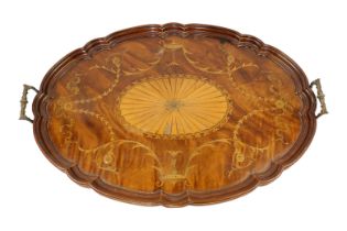 A Victorian mahogany and satinwood inlaid tray, of oval form with scalloped rim and brass carryin...