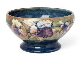 Moorcroft, a large orchid pattern footed bowl, c.1930s, glazed earthenware, the underside impress...