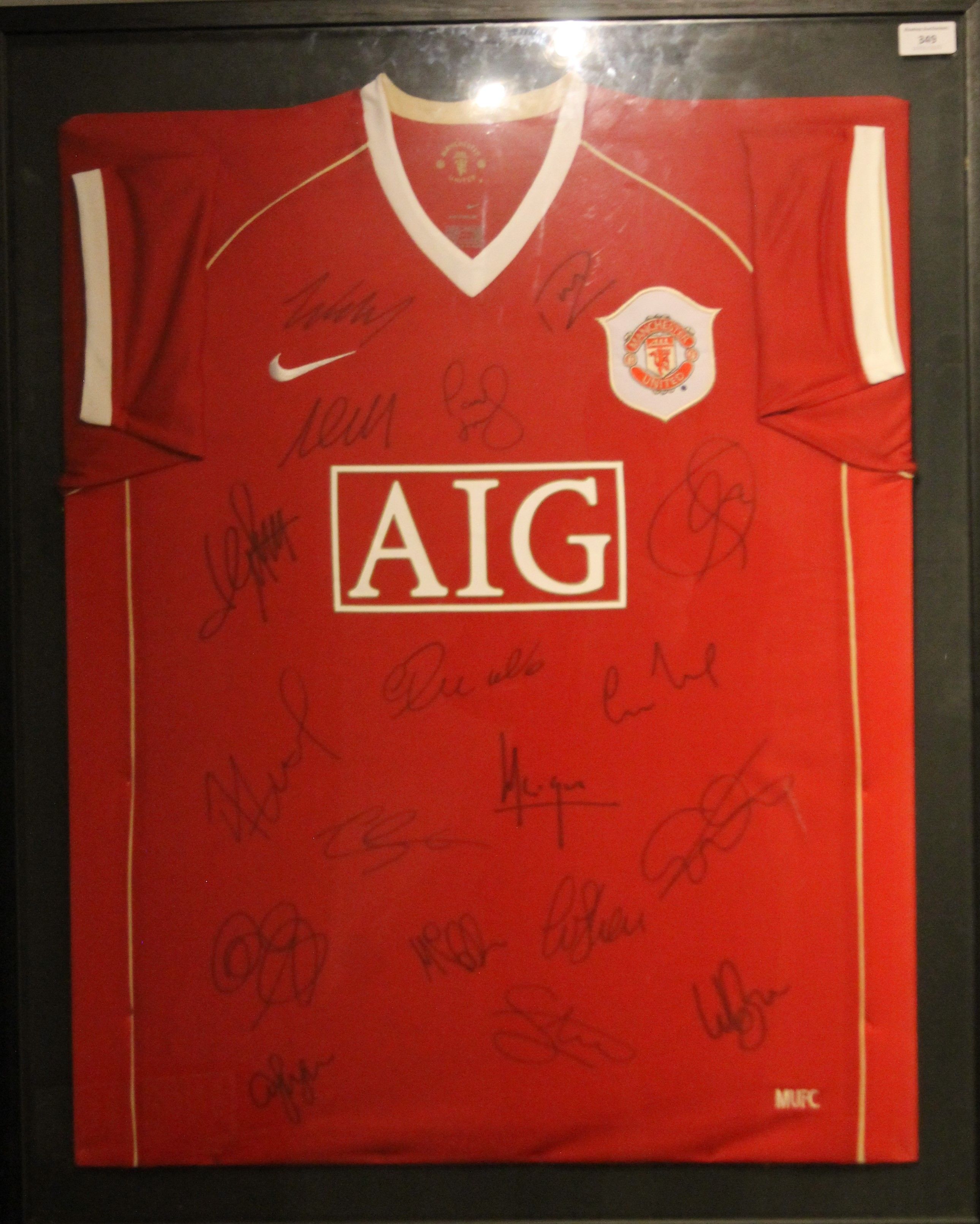 A framed and glazed signed Manchester United F C football shirt with certificate of authenticity.