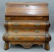 An 18th/19th century Dutch oak bombe bureau. Approximately 125 cm wide.