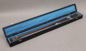 Four cased violin bows, the case with old Sotheby's label.