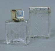 Two enamel and silver mounted cut glass dressing table jars. The largest 8.5 cm high.