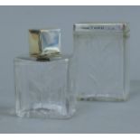 Two enamel and silver mounted cut glass dressing table jars. The largest 8.5 cm high.