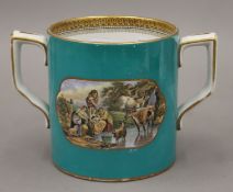 A 19th century Prattware two handle mug. 12.5 cm high.