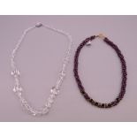 A garnet necklace and a crystal necklace.