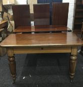 A Victorian mahogany wind-out extending dining table incorporating three later additional leaves.