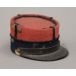 A French helmet form inkwell and a box formed as a hat. The former 3.5 cm high.