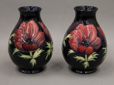 A pair of boxed Moorcroft vases. 18 cm high.