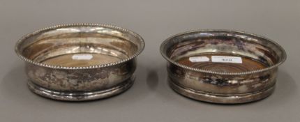 Two silver plated bottle coasters. The largest 15 cm diameter.