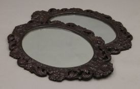 Two carved framed mirrors. 66 cm high.