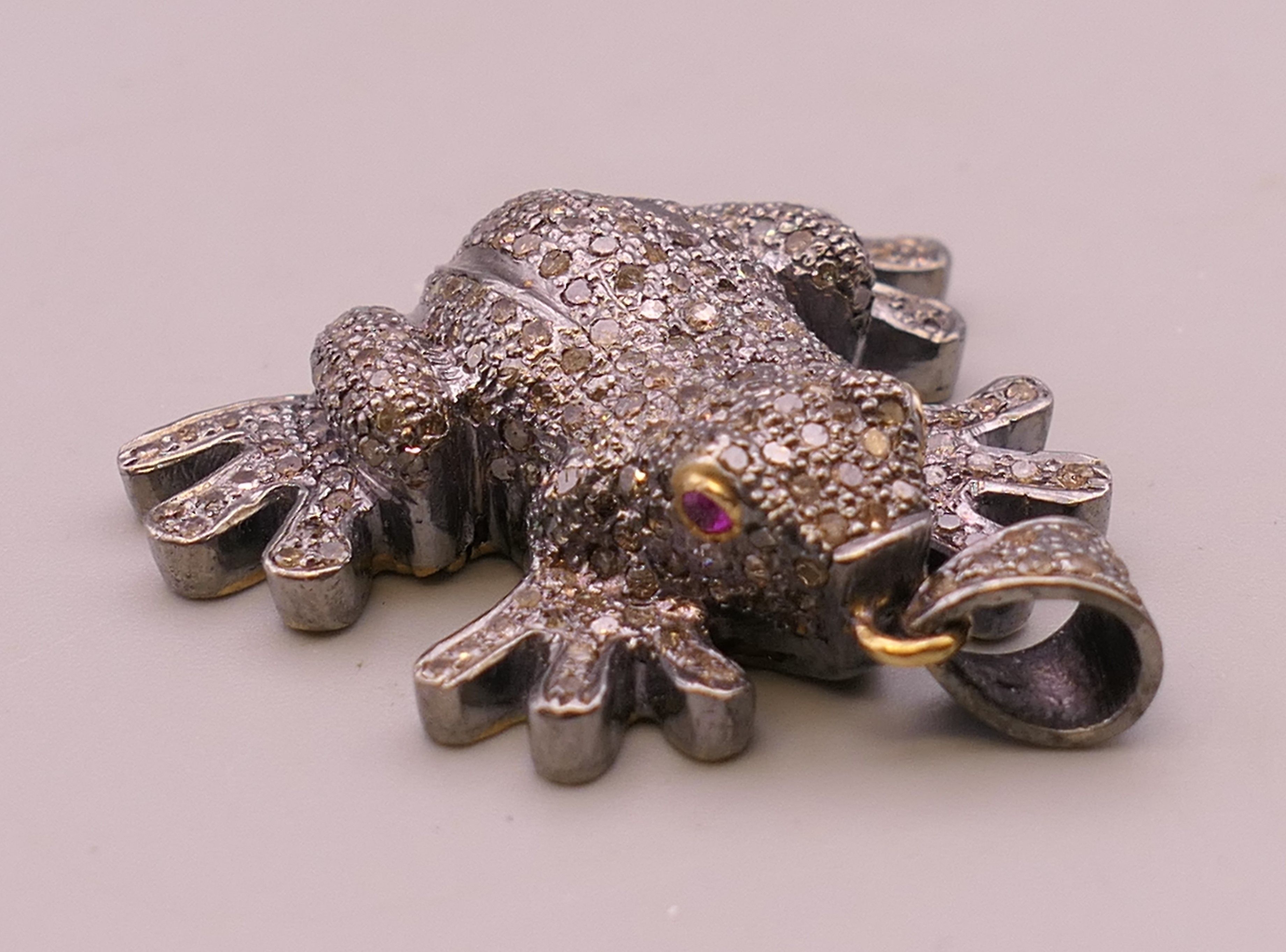 An unmarked diamond set pendant formed as a frog. 4 cm high. 16.3 grammes total weight. - Image 2 of 3
