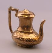 A 9 ct gold charm formed as a teapot. 2.2 grammes.