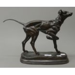 A bronze model of a dog. 39 cm long.