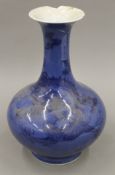 A 19th century Chinese blue ground porcelain vase decorated with a dragon. 30 cm high.