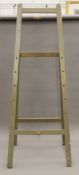 A vintage green painted artist's easel. 193 cm high.