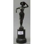 A bronze model of a girl guide mounted on a marble plinth base. 26.5 cm high.