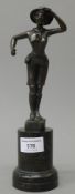 A bronze model of a girl guide mounted on a marble plinth base. 26.5 cm high.