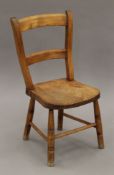 A elm seated child's chair. 32 cm wide.
