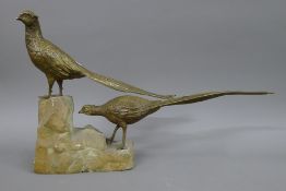A bronze model of two pheasants mounted on a stone plinth base. 38 cm high.