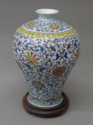 A large 20th century Chinese porcelain Meiping shaped vase, on a wooden stand. 36.5 cm high overall.
