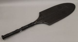 A Tongan carved wooden paddle club. 97 cm long.