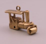 A 9 ct gold charm formed as a steam roller. 2.9 grammes.