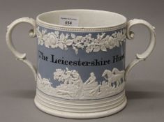 A 19th century twin handled hunt cup, inscribed 'The Leicestershire Hunt'. 15 cm high.