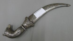 A 19th century Persian knife, the steel scabbard and grip inlaid with silver,