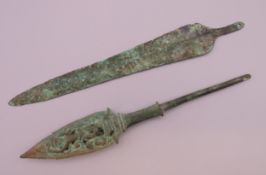 Two bronze arrow heads. The largest 20 cm long.
