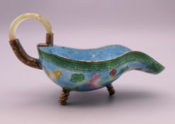 A Chinese basse-taille enamelled and gilded wine cup decorated with flowers,