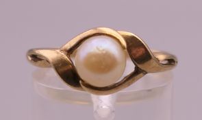 A 9 ct gold and pearl ring. Ring size P/Q. 2.2 grammes total weight.