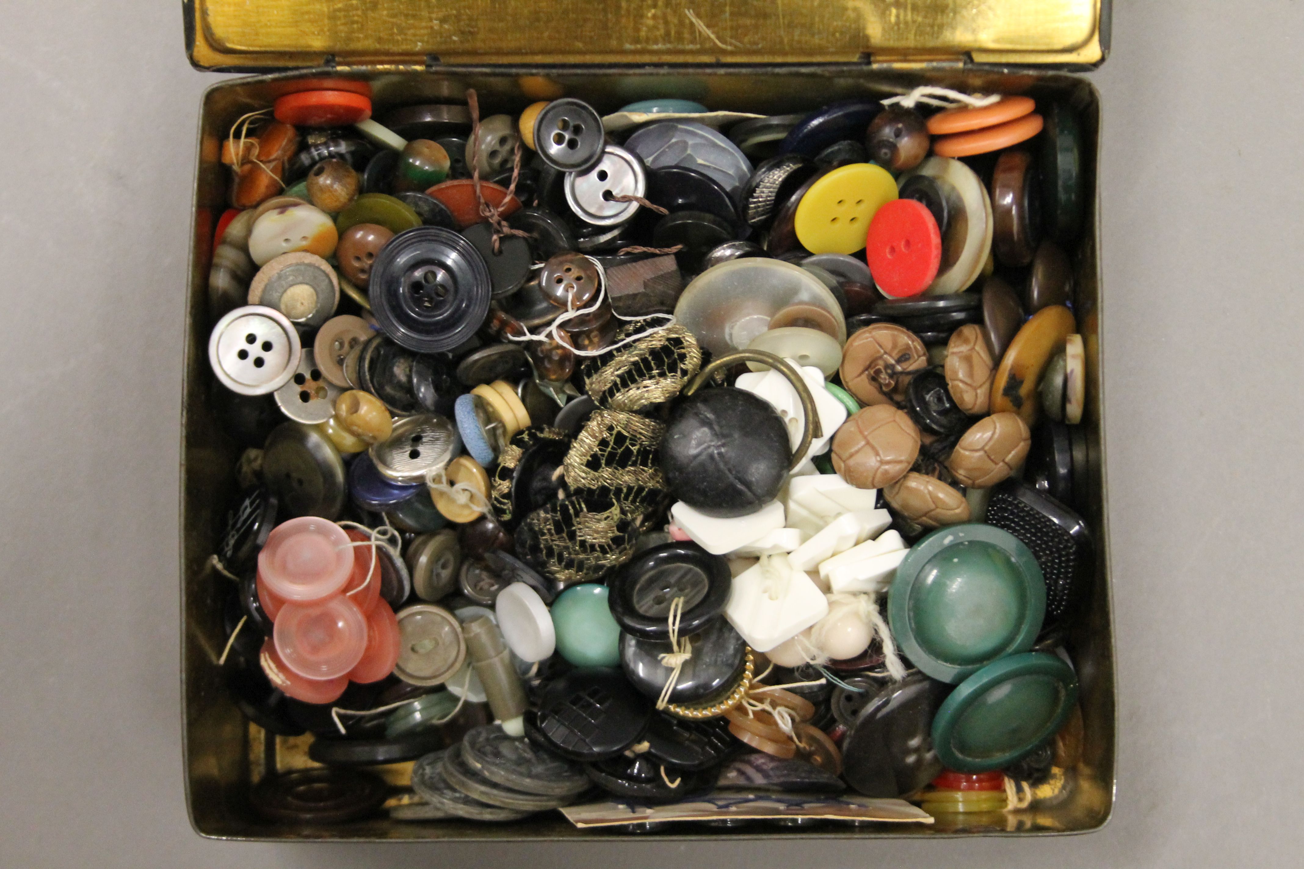 A tin of vintage buttons.