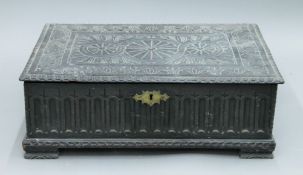 A 19th century carved oak bible box. 61 cm wide.