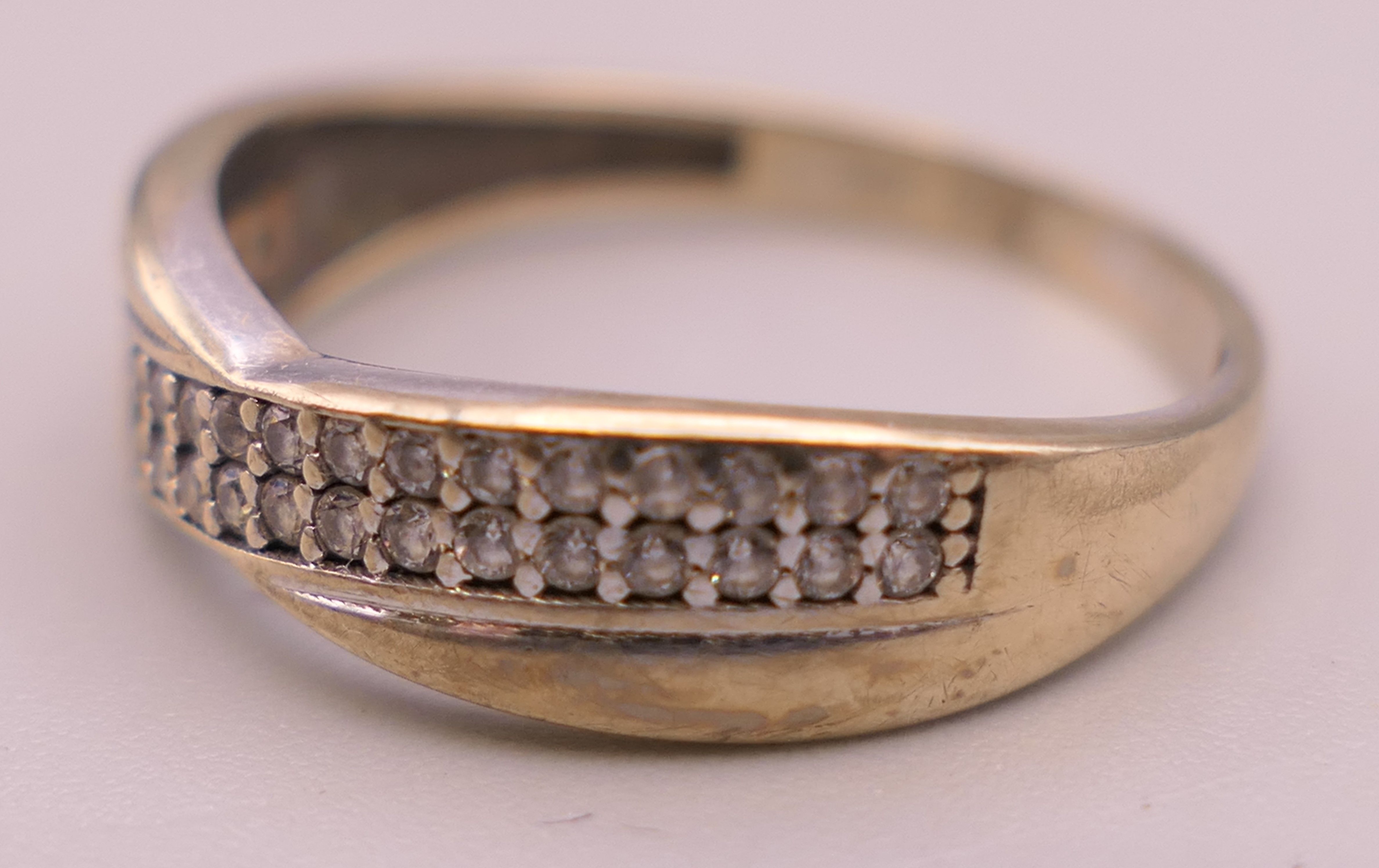 A 9 ct gold diamond set crossover ring. Ring size M. 1.3 grammes total weight. - Image 3 of 5