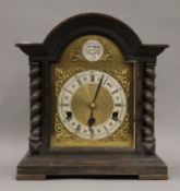 An oak mantle clock. 38 cm high.