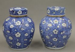A pair of 19th century Chinese porcelain ginger jars decorated with flowers and gilt highlighting.